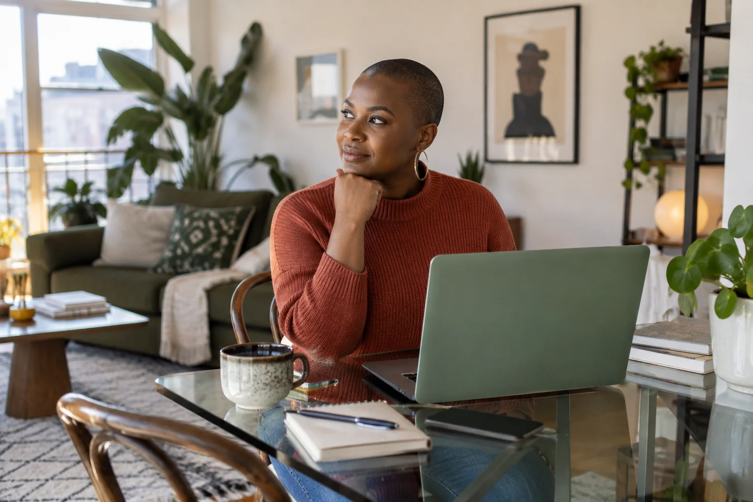Guest waiting at her laptop in a bright apartment.